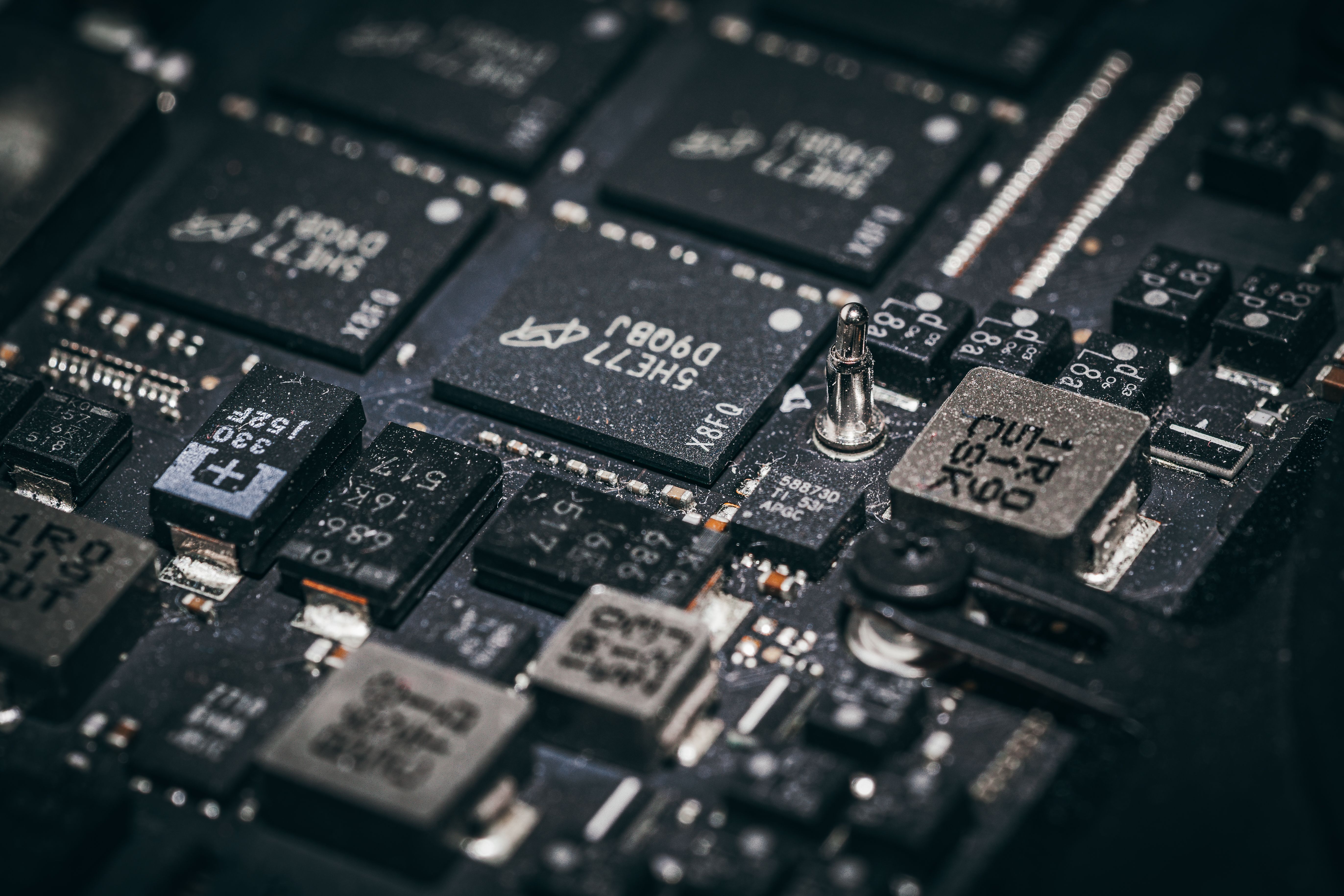 Macro view of electronic microchips on a circuit board, representing the sound module at the heart of an audio greeting card.