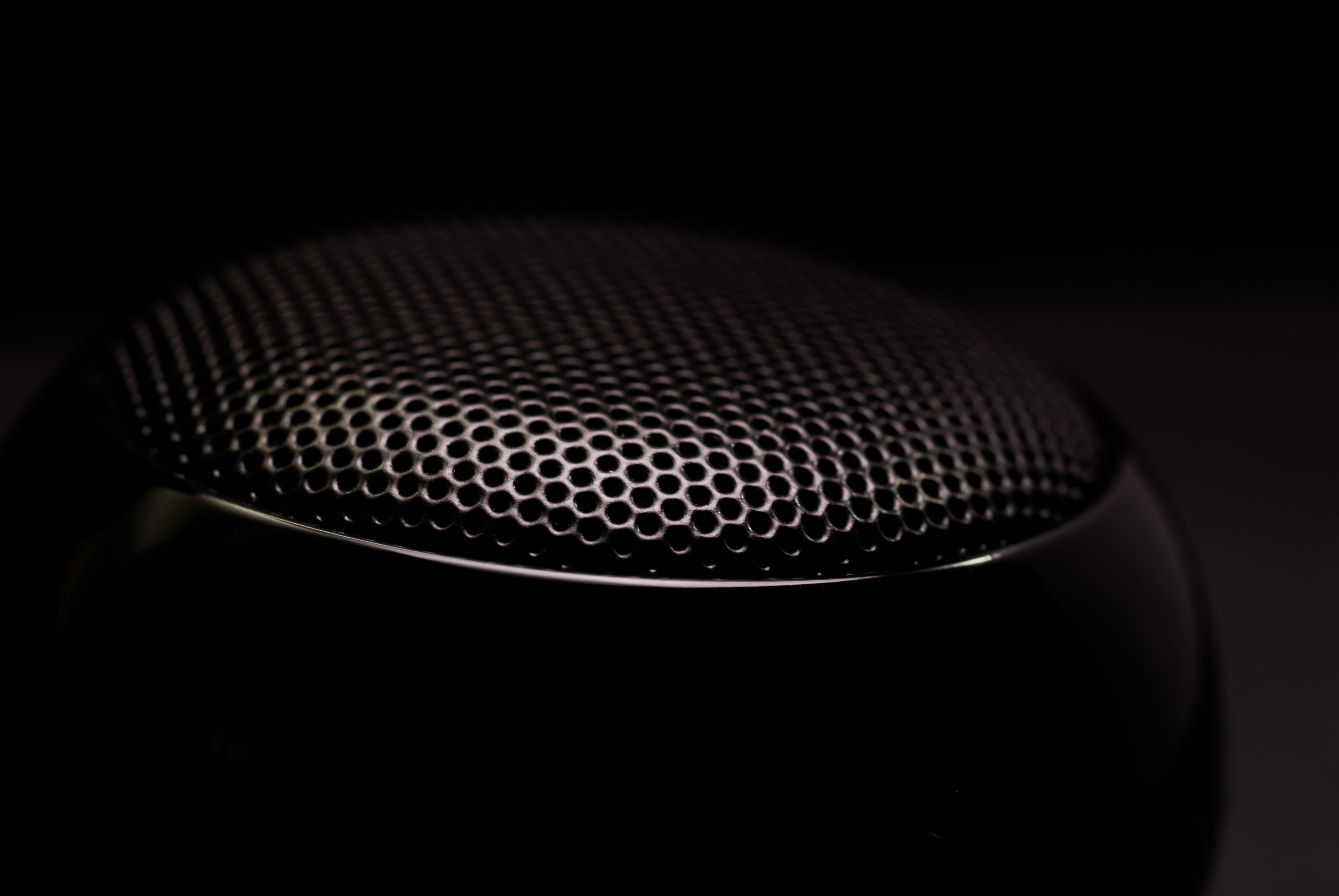 Close-up of a speaker grille representing the miniature speaker used to play sound inside an audio greeting card.